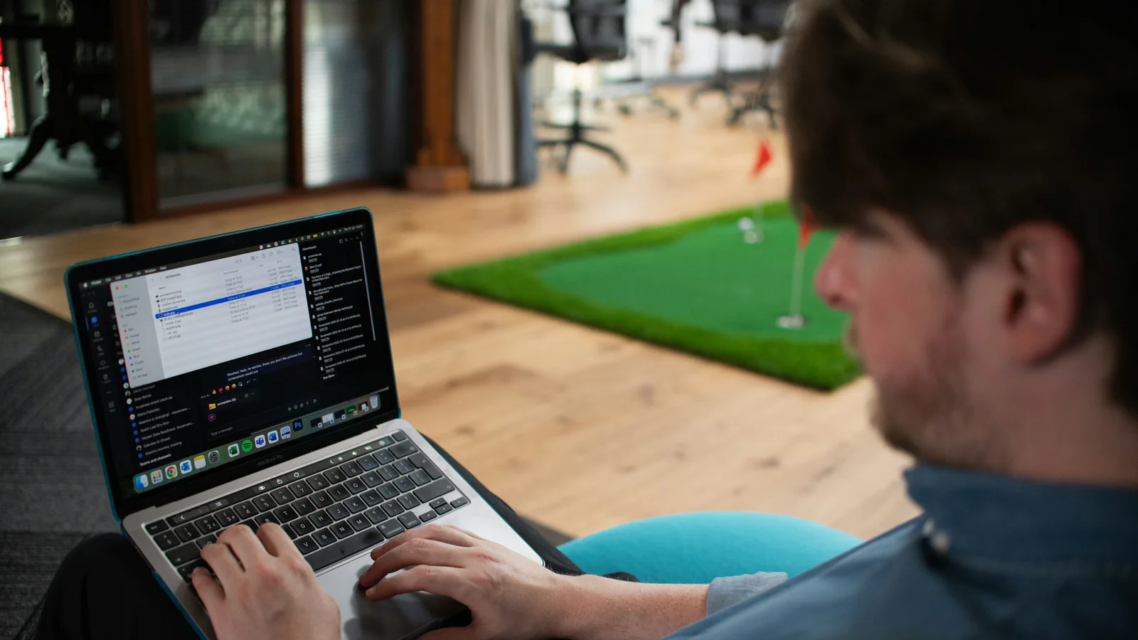 Person working on a laptop in a modern office
